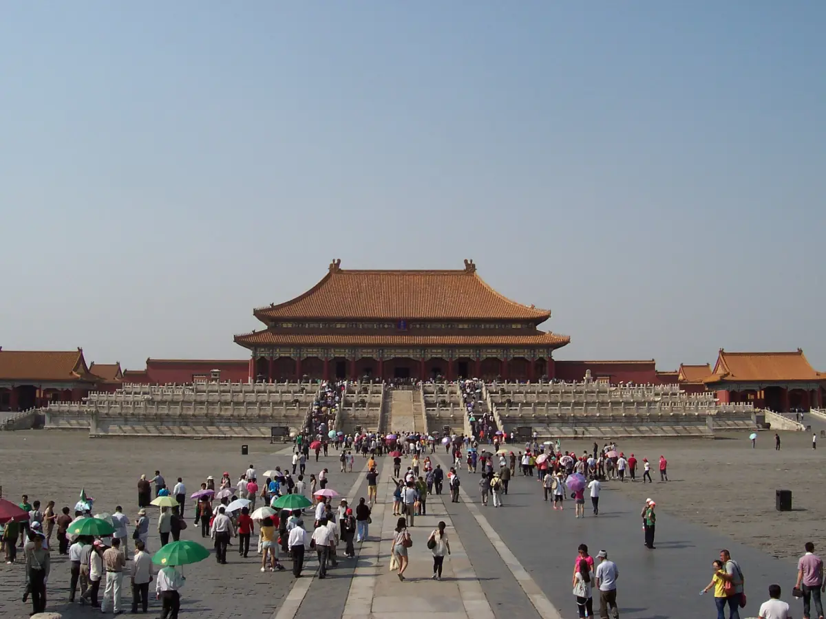 Visitors crossing the courtyard in front of the Hall of Supreme Harmony